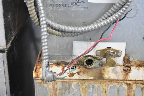 Manitowoc SD0602A commercial ice head on bin, shows electrical and water line connections. Voltage: 208-230, 1 phase. Used condition.