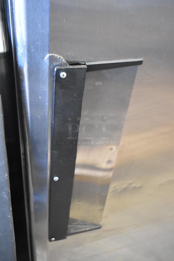 Turbo Air M3F24-1 reach-in freezer handle and door close-up, showing stainless steel surface and condition details.