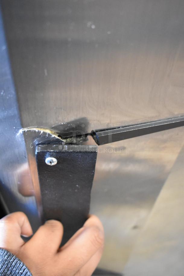 Turbo Air M3F24-1 commercial freezer with visible handle detail, minor wear. Features poly coated racks, 115V, 1 phase.