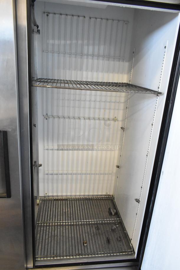 True T-49F commercial freezer interior, 2-door reach-in style with poly-coated racks, 115V, 1 phase. Clean condition.
