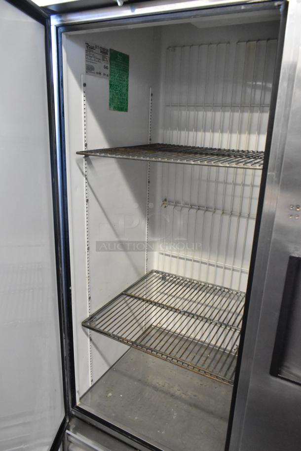 True T-49F commercial freezer with two doors and poly-coated racks. Power: 115V, 1 phase. Clean interior, visible model label.