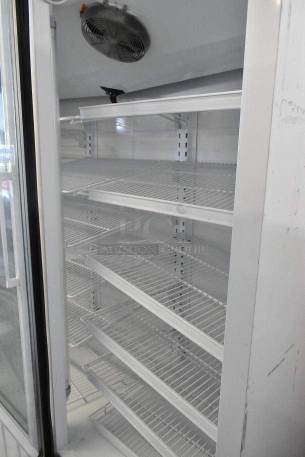 Master-Bilt BLG-80HD 3 Door Reach-In Freezer with poly-coated racks and casters; 115/208-230V, 1 Phase.
