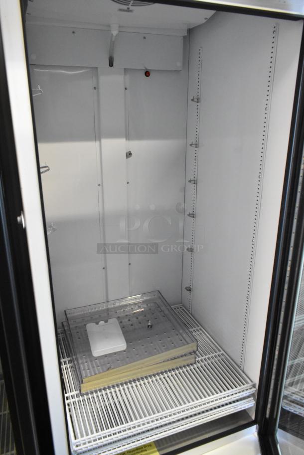 2021 True TSCI-600R-G-PH commercial reach-in cooler, single glass door, poly-coated racks, 115V, clean interior.