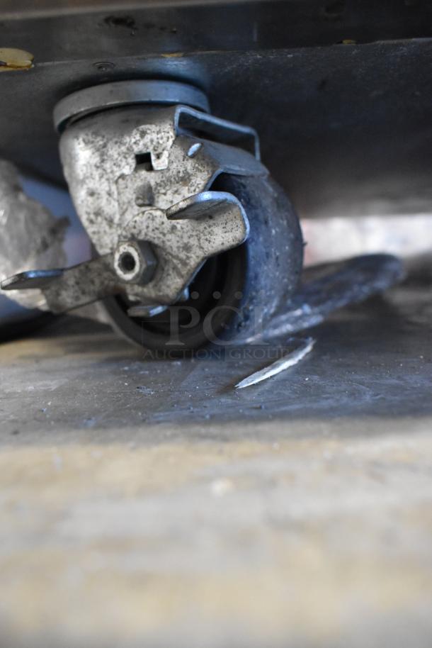 2019 Hoshizaki F2A-FS Commercial 2 Door Reach In Freezer caster wheel on worn surface. 115 Volts, 1 Phase.