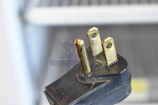 Close-up of a power plug from a 2019 Habco SE18 commercial cooler, showcasing the metal prongs.