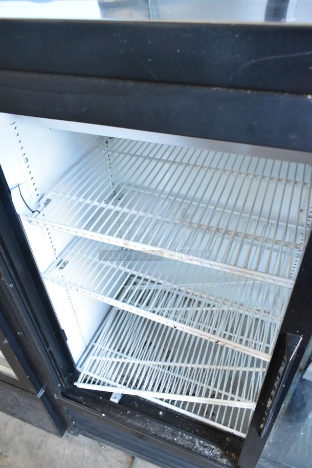 True Commercial 2 Door Reach-In Cooler Merchandiser with poly-coated racks, 115 volts, 1 phase, in good condition.
