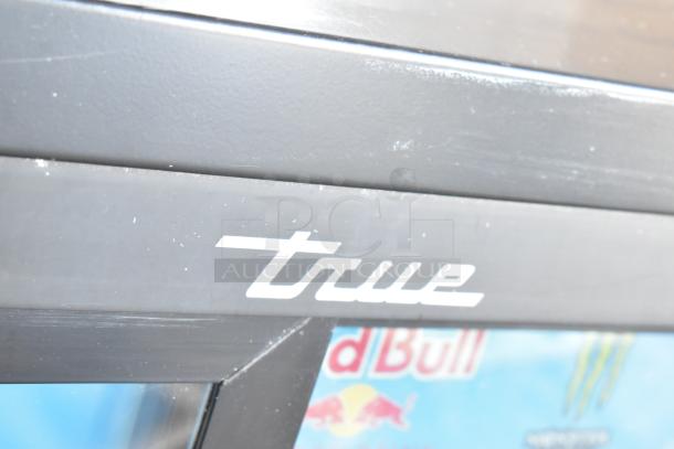 True Commercial 2 Door Reach In Cooler Merchandiser, poly coated racks, 115 volts, logo visible, well-maintained.