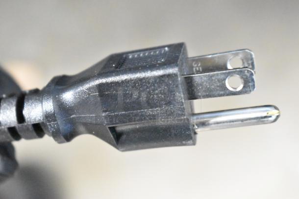 Close-up of a black power plug for the Avantco 178SSWT60RHC commercial refrigerator, showing prongs and plug details.