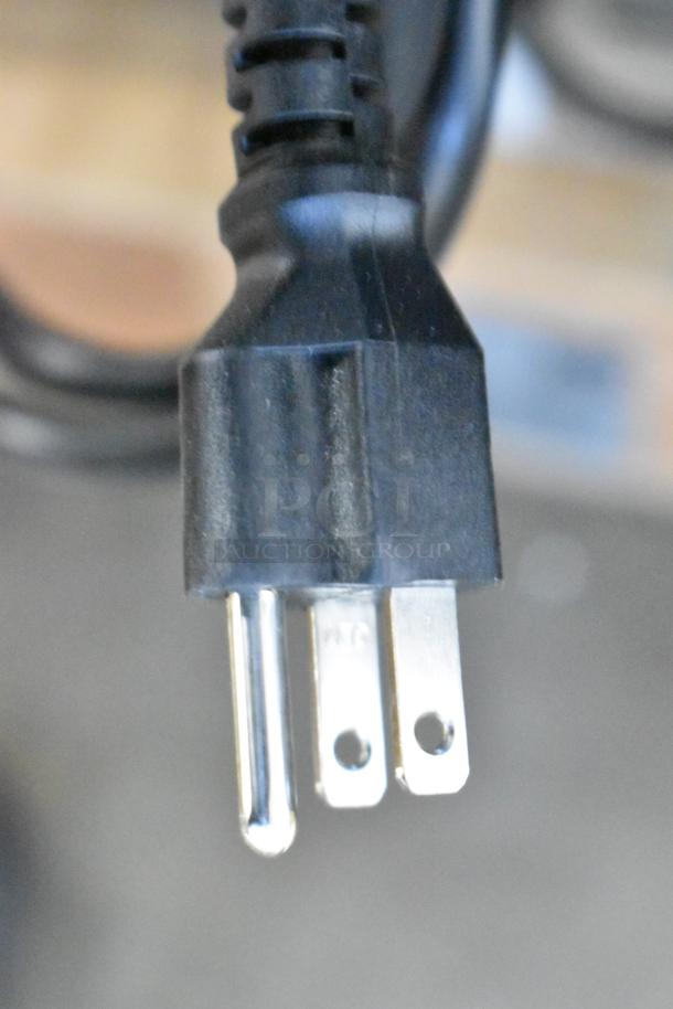 Close-up of a power plug for the Avantco 178UBB72GHCS back bar refrigerator, showing a standard three-prong design.