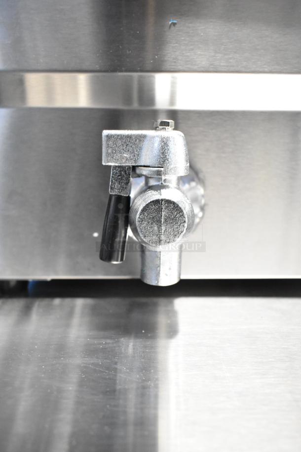 Close-up of the Avantco 177F202 fryer with a focus on its metal drain valve. The fryer is new, with minor scratches.