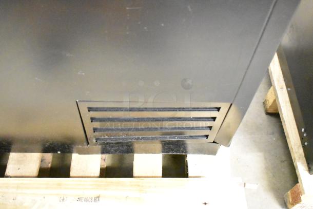 Brand new 2025 True TD-95-38-HC black horizontal bottle cooler with 3 sliding lids, 115 volts, slight dents visible.