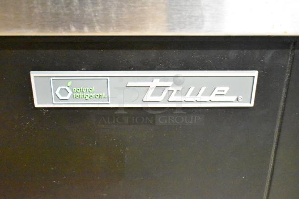 Brand new True TD-95-38-HC black bottle cooler with 3 sliding lids, 115V, 1-phase. Includes "natural refrigerant" label.