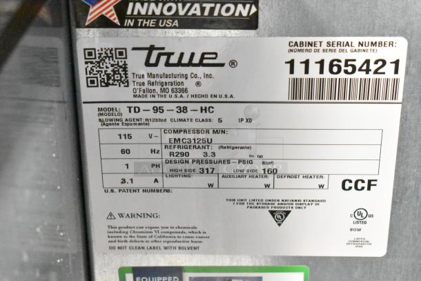 Brand new True TD-95-38-HC commercial bottle cooler, 115 volts, features 3 sliding lids. Scratch and dent condition. Model label details specifications.