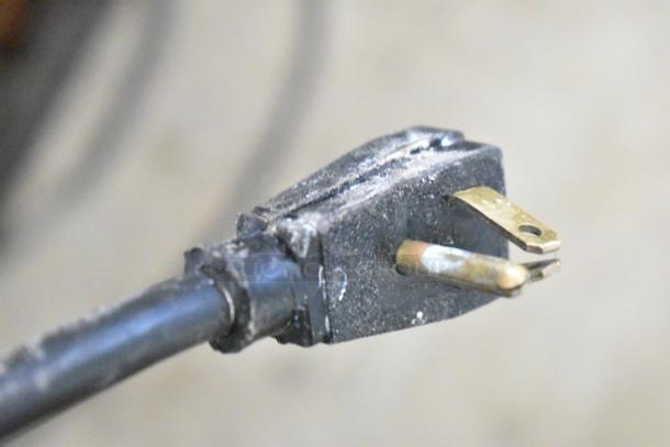Close-up of a plug from a True GDM-49 Commercial 2 Door Reach In Cooler Merchandiser. 115 volts, 1 phase power.