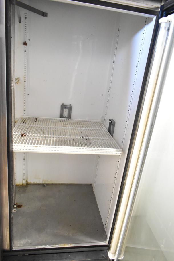 True GDM-49 2-door cooler merchandiser with poly-coated racks, visible wear, single phase, 115 volts.