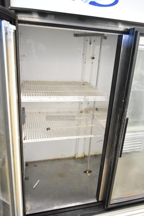 True GDM-49 commercial 2-door reach-in cooler with poly-coated racks. Visible wear, runs on 115 volts, 1 phase.
