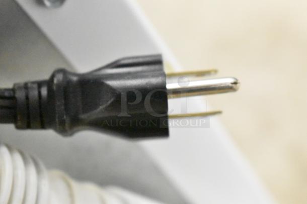 Close-up of a black appliance power plug.