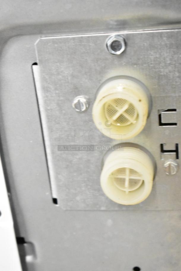 Close-up of water inlet valves on Speed Queen Alliance front load washer model AFN50FSP111TW01.