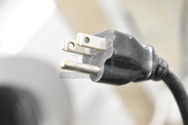 Close-up of a power plug for Speed Queen Alliance AFN50FSP111TW01 washer and ADG4BFGS111TW01 dryer.
