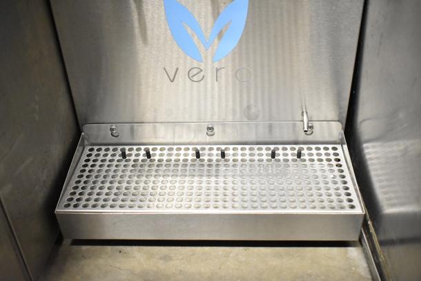 Vero Commercial Countertop Water Dispenser in stainless steel, featuring a perforated drip tray. Logo visible, minimal wear.