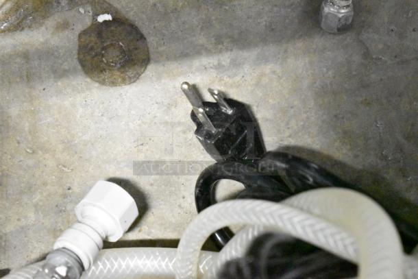 Vero Commercial Countertop Water Dispenser power cord and plumbing connections on concrete floor.