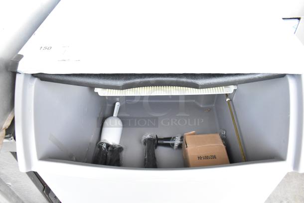 Brand new Ice-O-Matic ICEU220FA5 ice machine interior, showing 70 lb. bin and accessories. Scratch and dent condition.