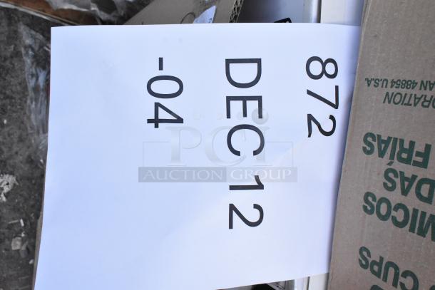 Box of 25 brand new scratch and dent items including bus tub, dispenser, cold cups, and containers. Tag reads "872 DEC 12 -04".