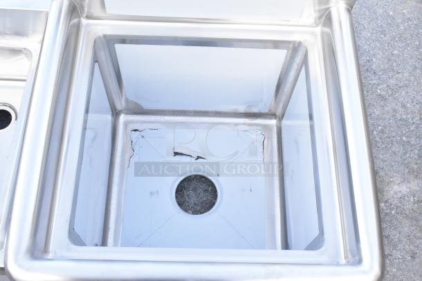 Stainless steel sink with visible scratches and dents, new condition. Interior drain hole, reflective surface.