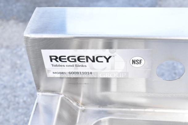 Regency stainless steel sink corner showing brand label, model 600B11014, and NSF certification. New condition.