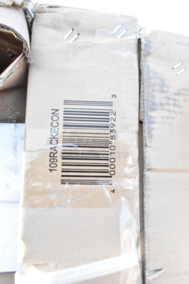 Alt text: Cardboard box with a visible barcode labeled "109RACKECON." Contains scratch and dent items like a blue chair, sinks, and pan racks.