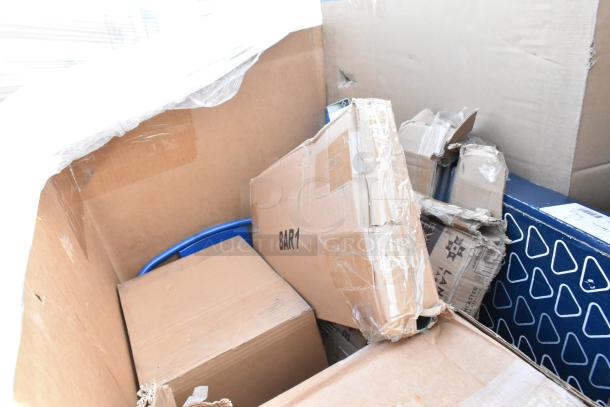 Bulk lot of 13 new scratch and dent items, including a blue chair, sinks, and pan racks in mixed-condition packaging.