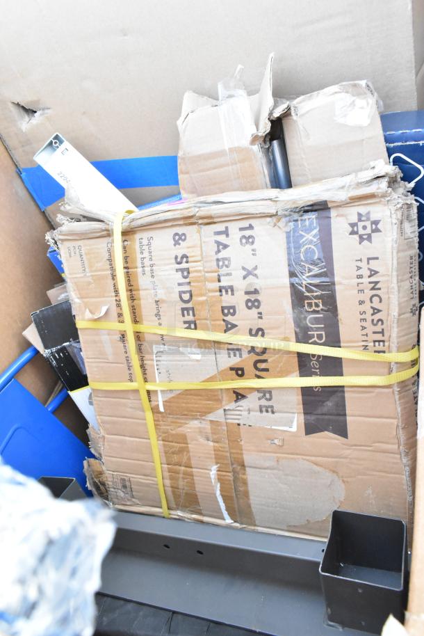 Damaged boxes containing Lancaster table bases, blue chair, and miscellaneous items. Scratch and dent condition.