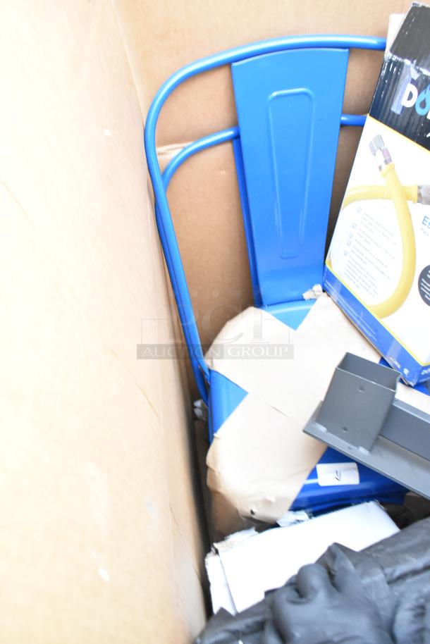 Auction lot of 13 items including a blue metal chair, partially visible, alongside other boxed items in a cardboard container.