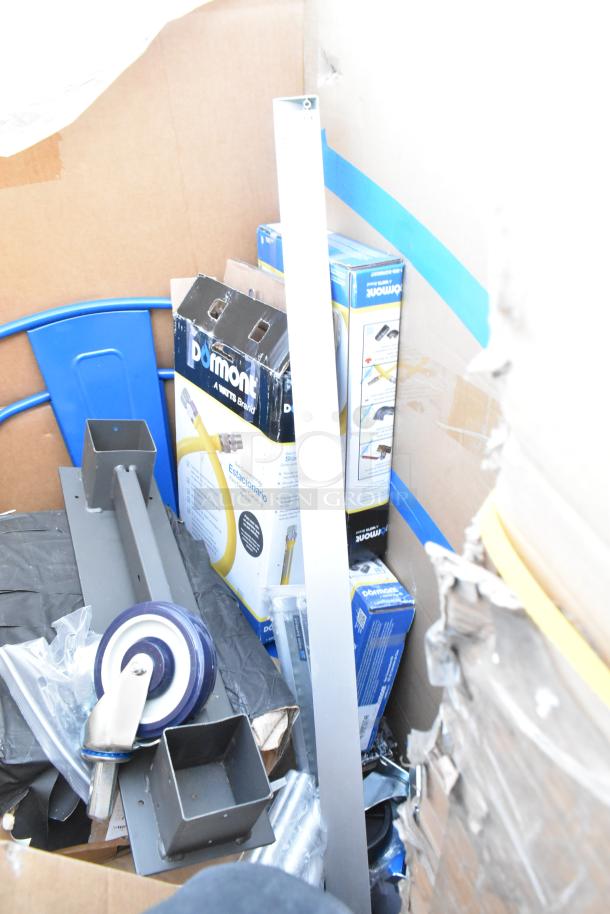 Box of mixed new scratch and dent items including blue chair parts, Dormont boxes, and metal components.