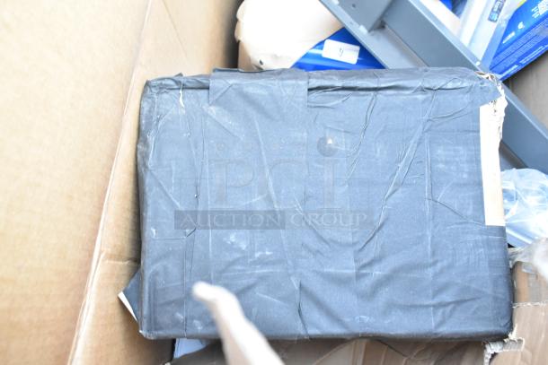Image showing a black-wrapped item in a cardboard box, part of a lot labeled "13 BRAND NEW SCRATCH AND DENT!" auction items.