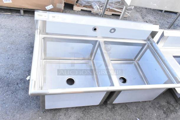 Brand new Regency 600S22424 stainless steel 2-bay sink, no legs. Visible scratch and dent. Markings include model info.
