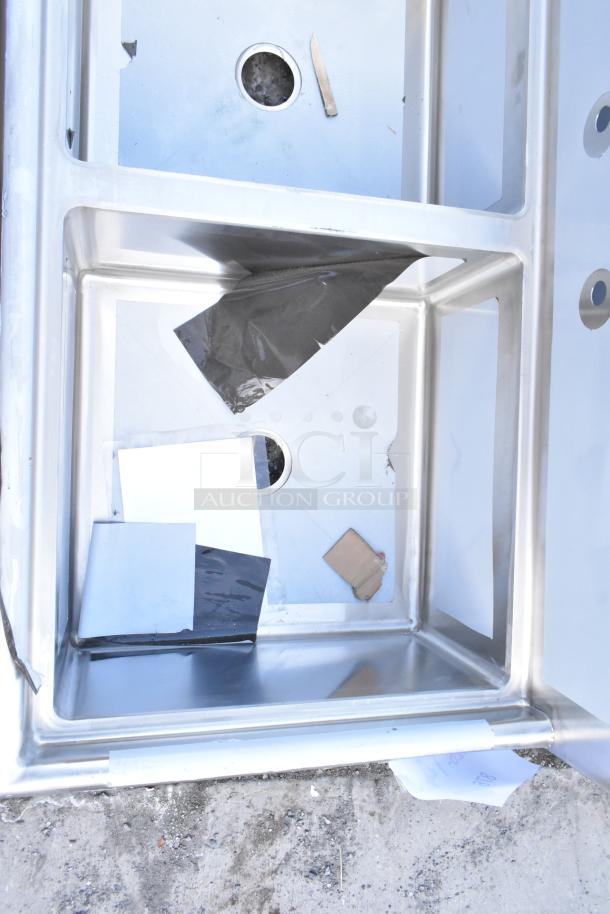 Brand new Regency 600S32323 stainless steel three-compartment sink, 78", 16-gauge, visible scratches, no legs, no drainboard.