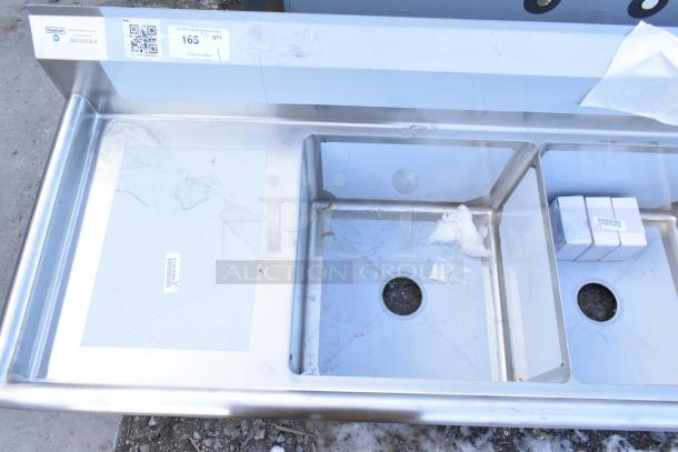 Brand new Steelton 522CS31818LR stainless steel 3 bay sink with dual drain boards. Visible label and light scratches.