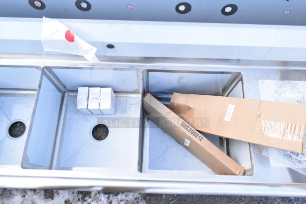 Steelton 522CS31818LR stainless steel 3 bay sink with dual drain boards, new with scratch and dent, items in sink include boxed tap parts and labeled packaging.