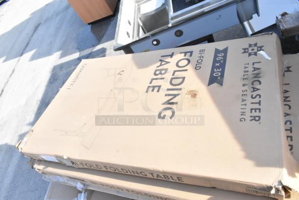 Lancaster 96"x30" bi-fold table in box, slight packaging damage. Includes wire shelf, new scratch and dent items, 12 pieces total.