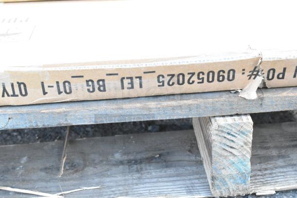 Cardboard box labeled "Qty 1-01-BG-Let" on wooden pallet, possibly containing brand new scratch and dent items.