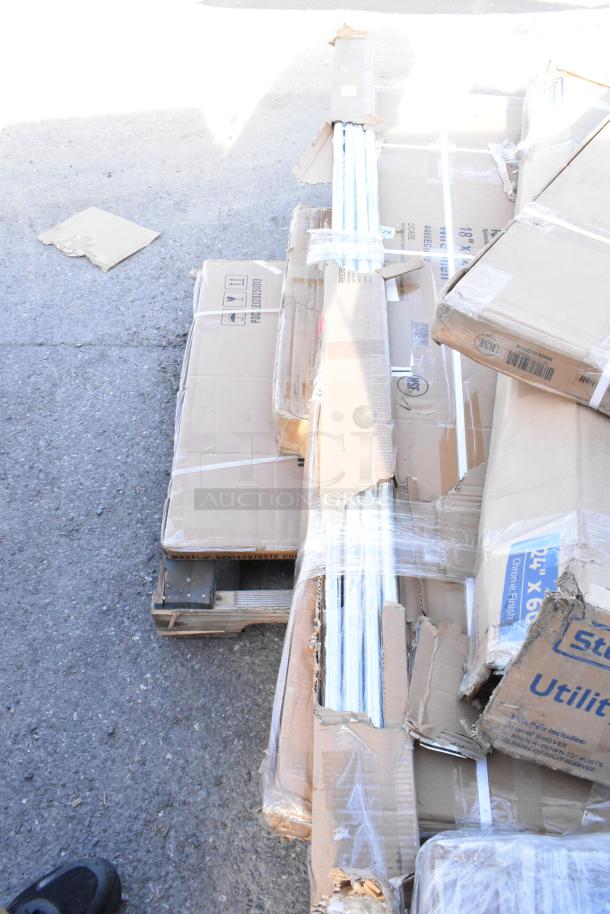 Bundle of scratch and dent items in boxes, including a wire shelf and bi-fold tables, visible labels indicate size and packaging details.