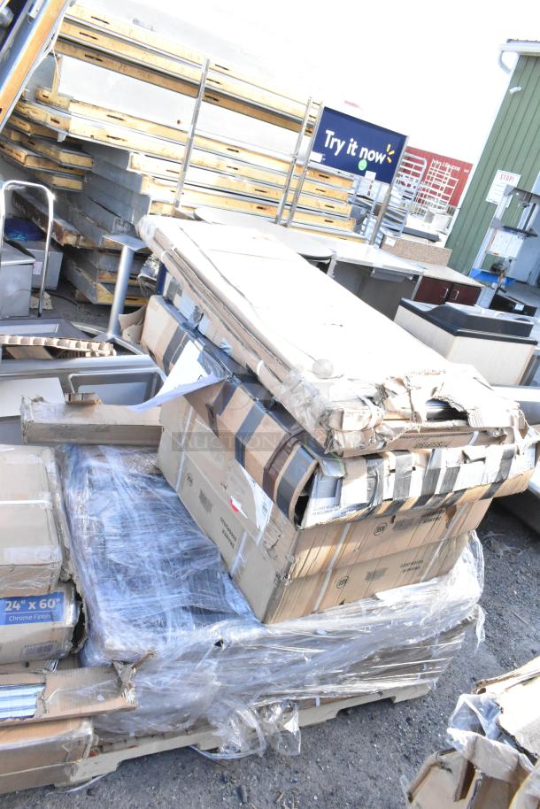 14 new scratch and dent items including table base columns and a drawer, boxed and shrink-wrapped on a pallet.