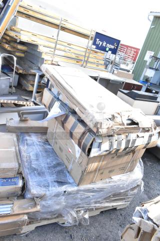 14 new scratch and dent items including table base columns and a drawer, boxed and shrink-wrapped on a pallet.