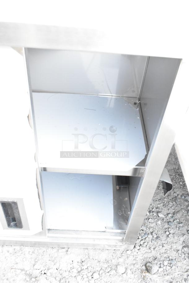 BRAND NEW Regency 600WCS1524 24" stainless steel wall cabinet with sliding doors; visible scratches and dents.