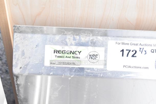 BRAND NEW Regency 600S1242418L stainless steel single bay sink with left drain board, minor scratches, model label visible.