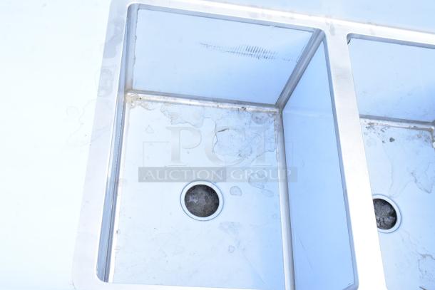 Regency 600S3182418L stainless steel 3 bay sink, scratch and dent, with left side drain board. No legs included.