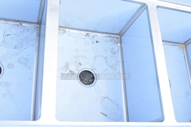 Brand new Regency 600S3182418L stainless steel 3-bay sink with left side drain board, scratch and dent, no legs.