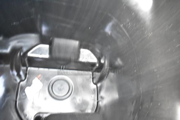 Inside view of a Lavex black poly trash can, showing smooth interior finish and side handles. Item is new with minor defects.