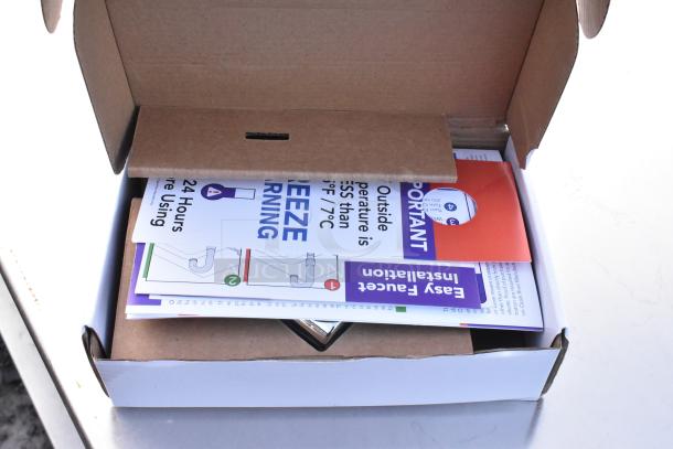 Cardboard box with installation instructions for Ozark River hot water hand sink. Includes "Freeze Warning" notice.